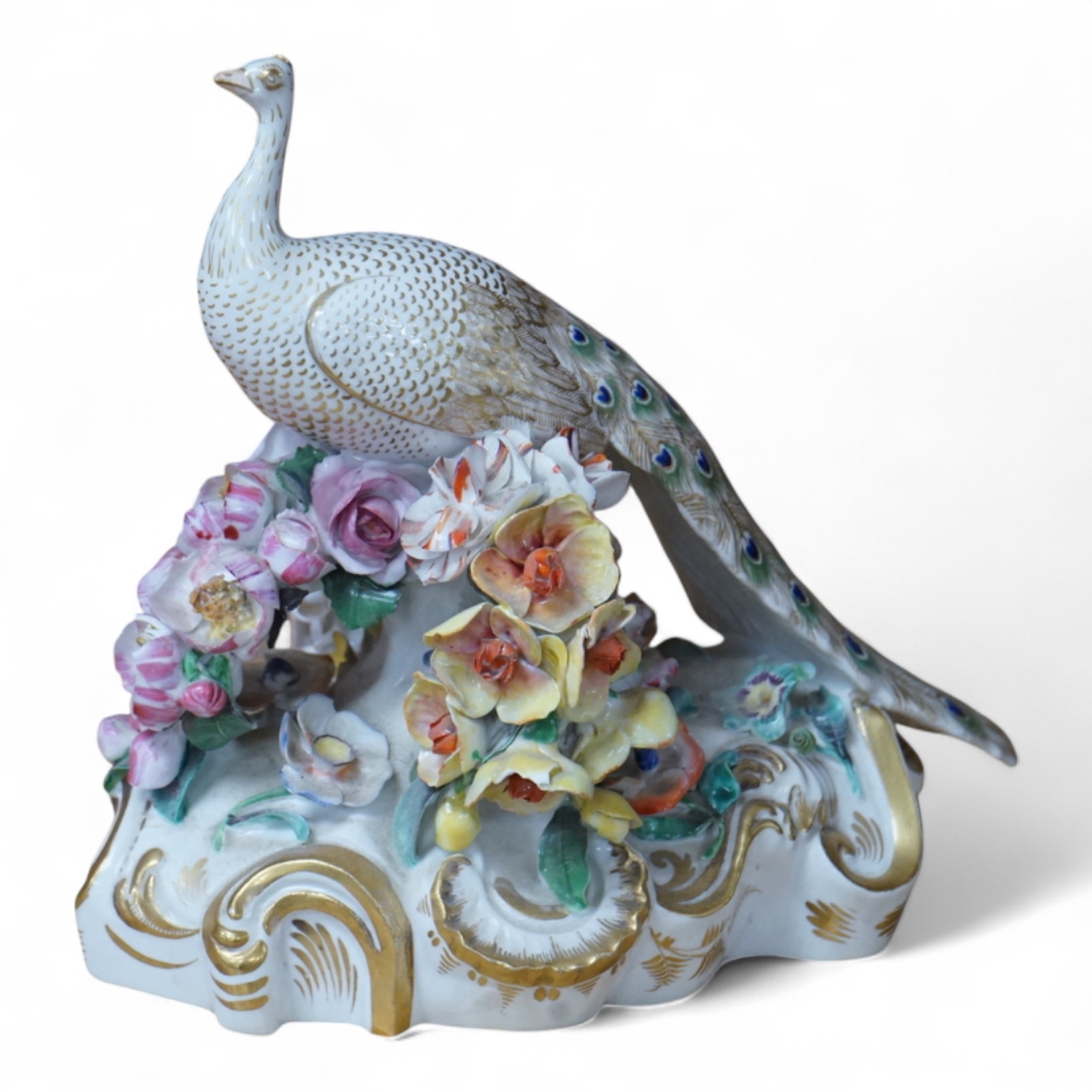 An ornate Bloor Derby peacock with floral encrusted decoration, 16cm high